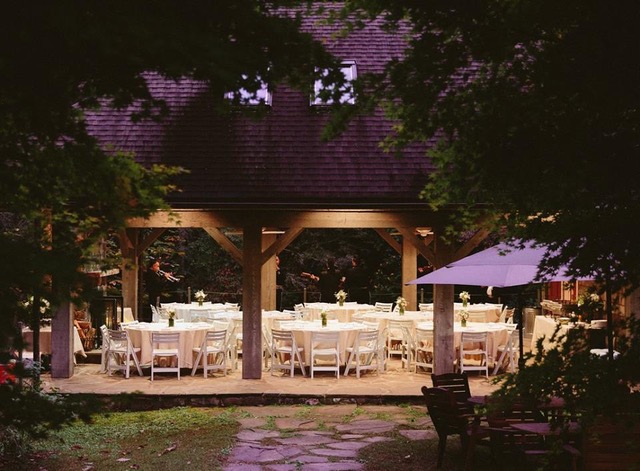 Gazebo with white tables and a purple roof